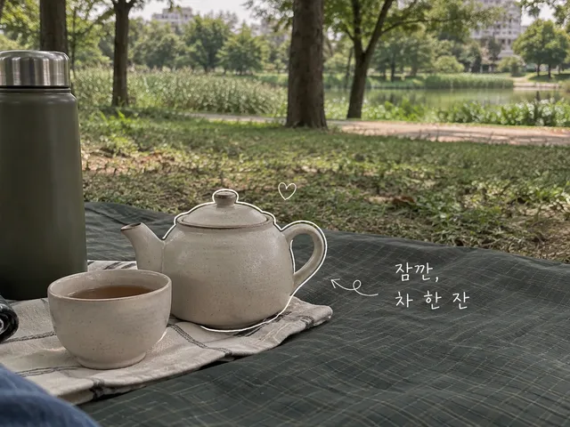 공원 돗자리 위 작은 다관과 찻잔, 보온병에 흰 손글씨를 더한 AI 생성 이미지.